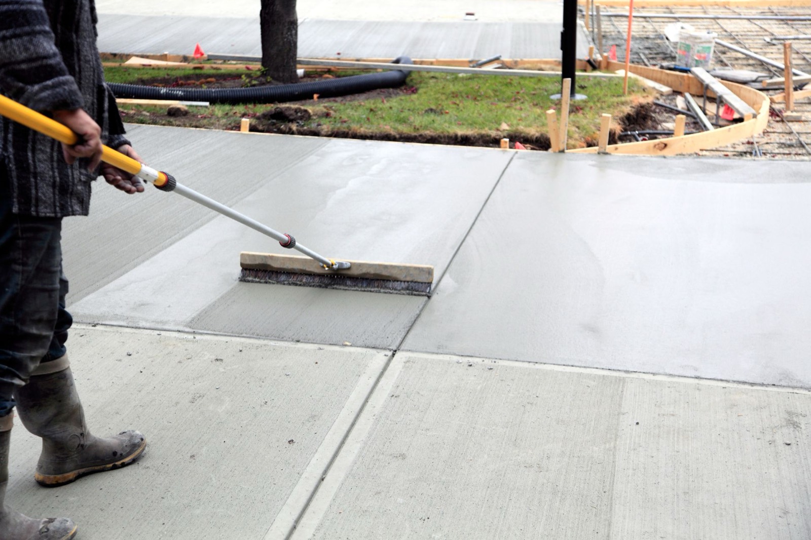 Broom finish being applied to fresh concrete in Toronto