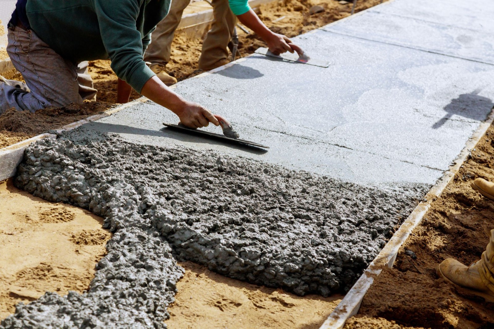 Crew screeding a fresh concrete pour in the GTA