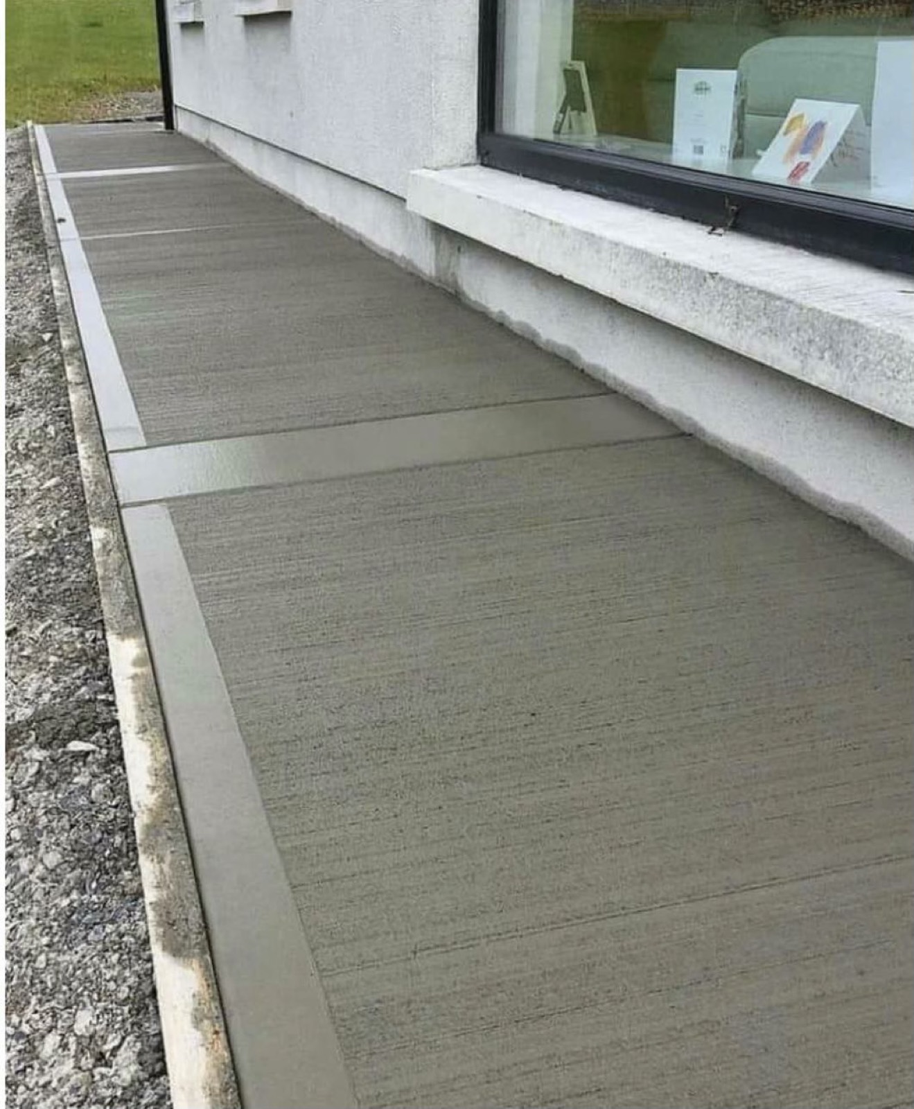 Broom-finish concrete along the foundation wall of a Toronto house